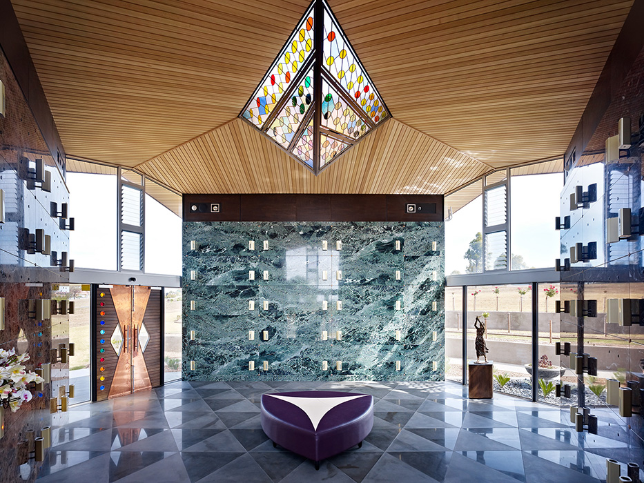 Mausoleum interior with coloured glass skylight, copper doors, bluestone tile floor, copper and hardwood doors,