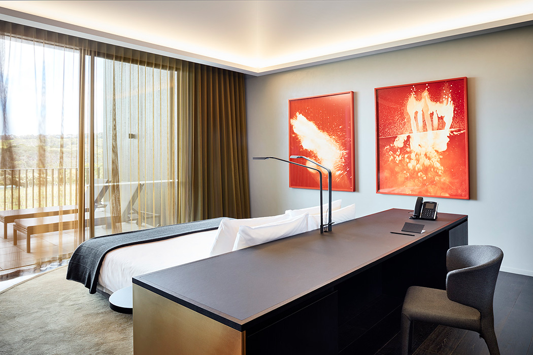 Hotel room with bright orange artwork - example of hotel/ restaurant photography by Rhiannon Slatter