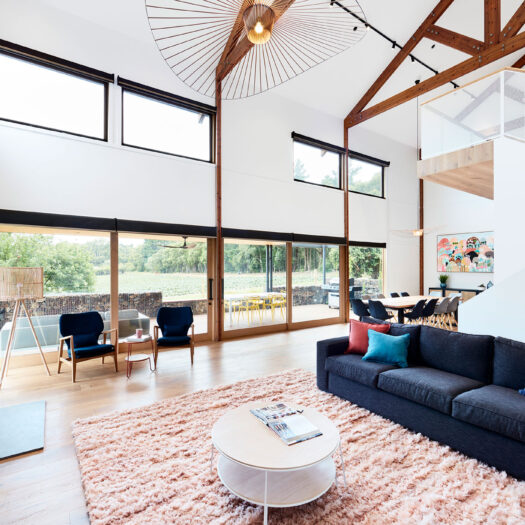 Main Ridge Barn interior with soft furnishings, high ceilings and feature pendants - building photographer example / concept