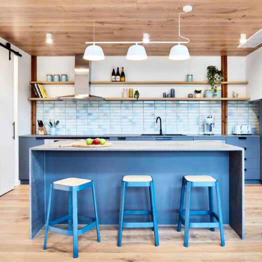 Main Ridge Barn kitchen with feature blue and sliding barnyard door - building photographer example / concept