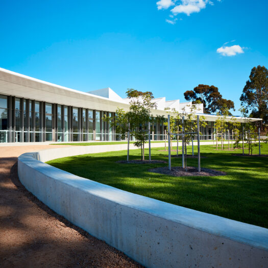 Nunawading Community Hub curved concrete garden edge with glass building facade behind - structure photographer example / concept COMMUNITY HUB 5