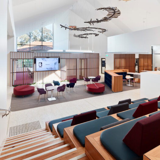 Nunawading Community Hub reception and administration area with stairs and tireed seating and various types of communal seating - structure photographer example / concept