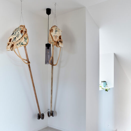 Tamar House - sculpture with horse skulls in hallway - building photographer example / concept