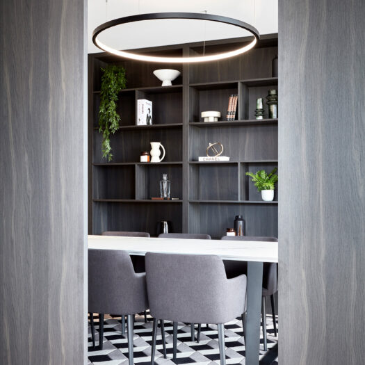 Hawthorn Park view through doors into private dining room with dark timber shelves and decorative items - building photographer example / concept