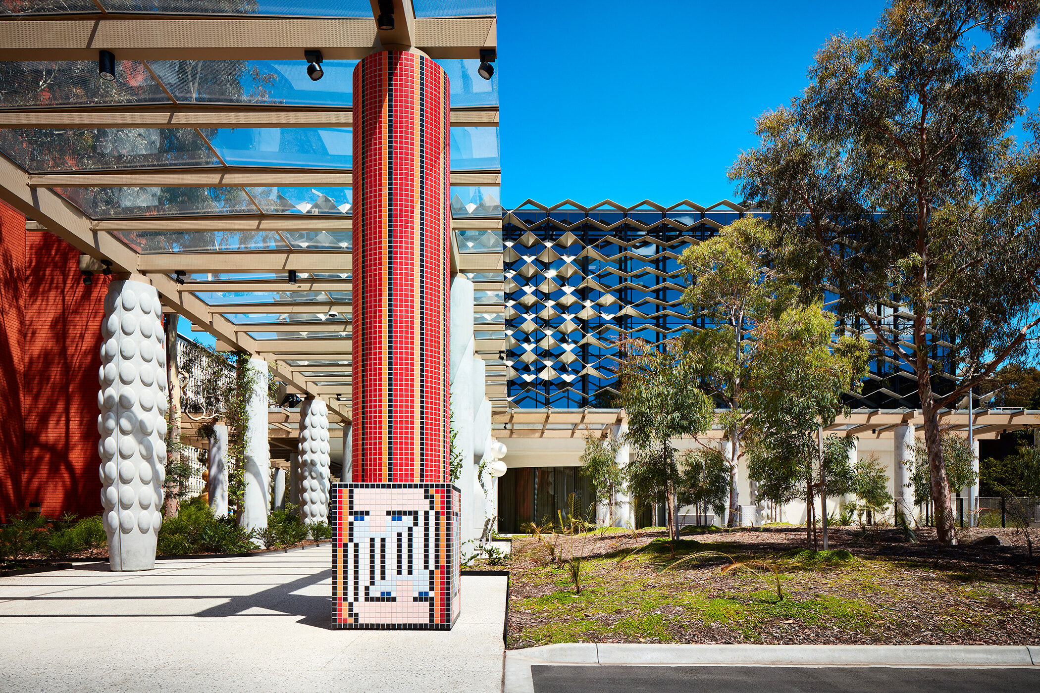 Monash University Chancellery red tile mosaic artist column with building in background - University example / concept