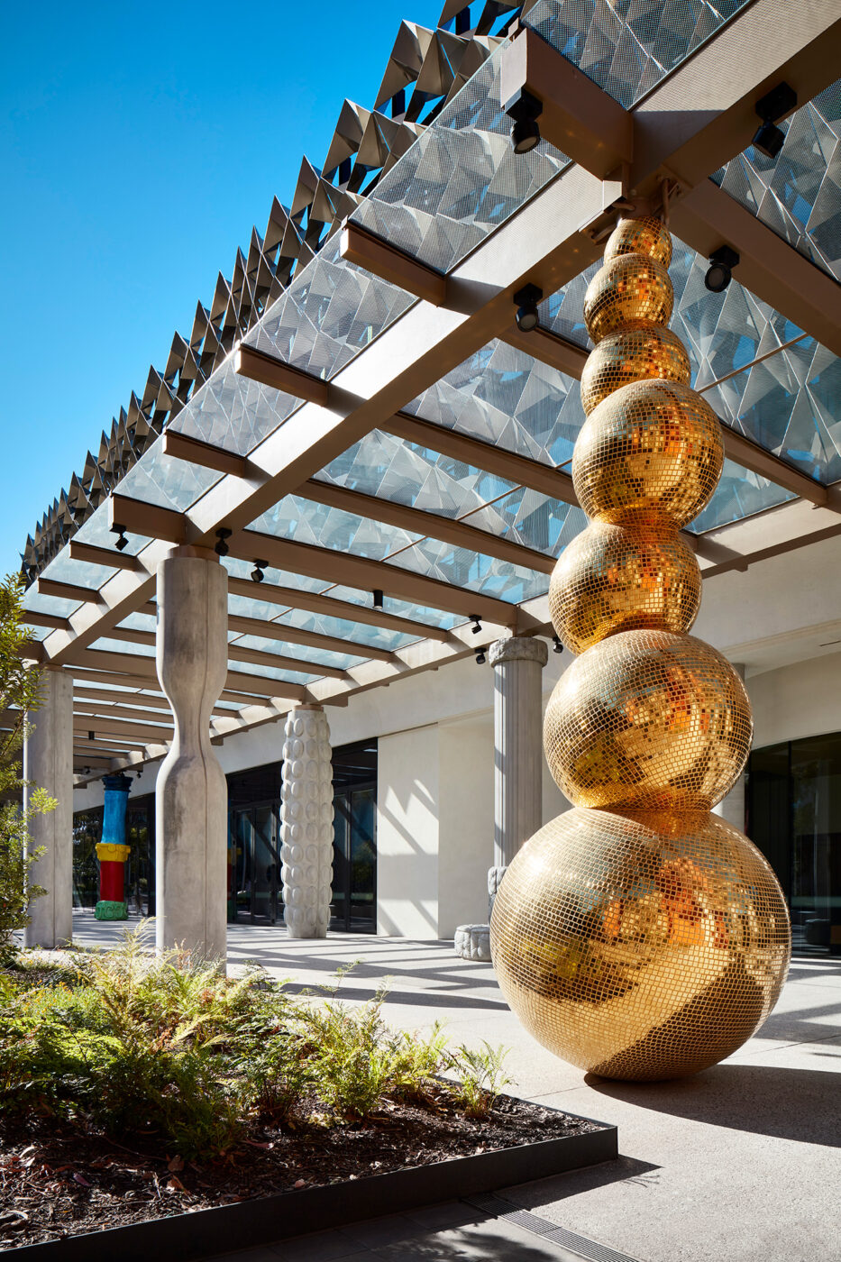Monash University Chancellery featuring brilliant golden sculpture reflecting sunlight - University example / concept