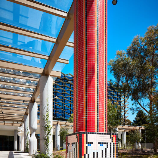 Monash University Chancellery red tile mosaic artist column looking through colonnade to building - University example / concept