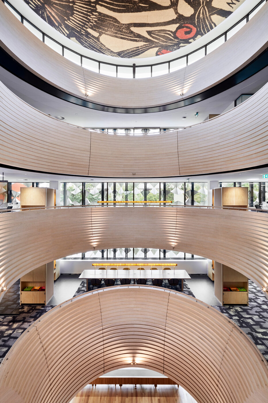 Monash University Chancellery elevated view through atrium void looking out through steel mesh and into tearooms on each level - University example / concept