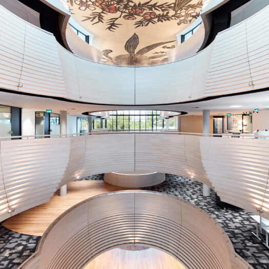 Monash University Chancellery elevated view through atrium space with floral artork on ceiling and views into open plan offices - University example / concept
