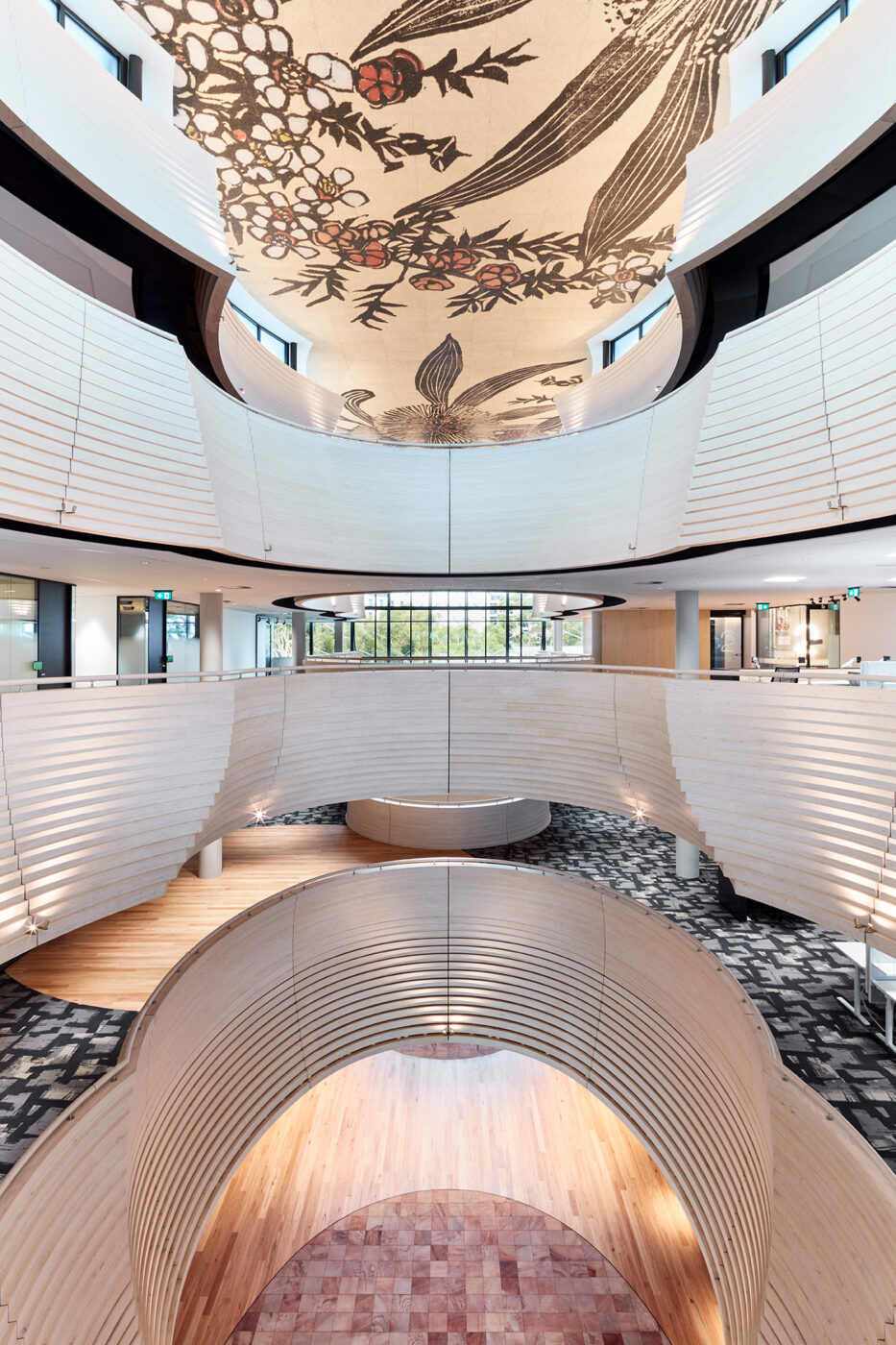 Monash University Chancellery elevated view through atrium space with floral artork on ceiling and views into open plan offices - University example / concept