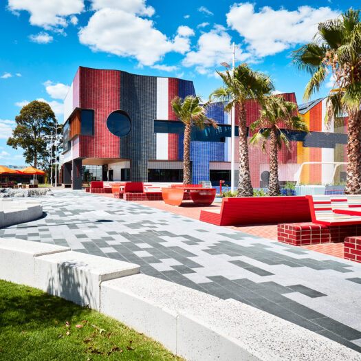 Springvale Library and Community Hub red ourdoor communal tiles and paving with rainbow building - structure photographer example / concept