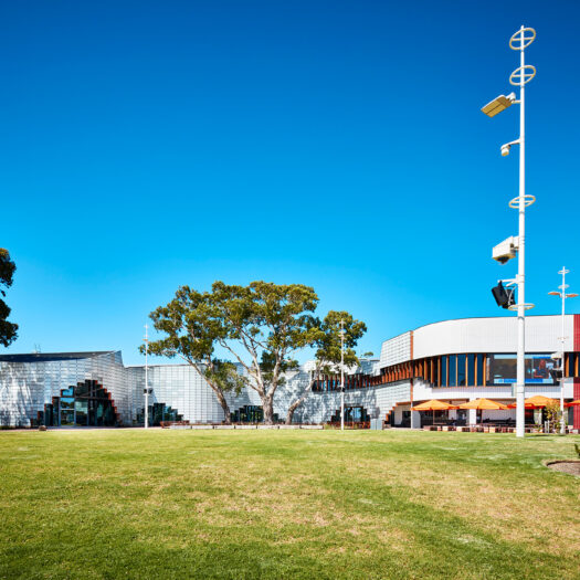 Springvale Library and Community Hub sloping lawn towards building with arched entries - structure photographer example / concept